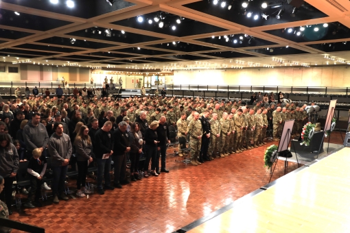 New York National Guard Soldiers assigned to the 42nd Expeditionary Combat Aviation Brigade, along with the family and friends of Chief Warrant Officers 2 John Grassia III and Casey Frankoski, fill the Empire State Convention Center in Albany during a uni